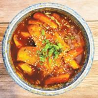 Spicy Rice Cake · Spicy and chewy rice cake simmered with vegetables and fish cakes topped with garlic and sca...