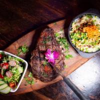 Bone in Rib Eye Steak · Our 18 oz. rib-eye steak grilled to perfection and served with mac and cheese and saute vege...