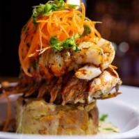 Lobster Fongo · 8 oz. of braised Brazilian lobster tail over a Puerto Rican style mofongo of plantains and y...