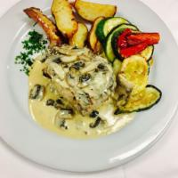 Stuffed Pork Chop · Filled with spinach, roasted peppers and Gorgonzola, and finished in a mushroom and brandy c...
