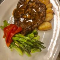 Cow boy steak  · 16oz cowboy steak topped with mushrooms Marsala sauce served with vegetables and potatoes 