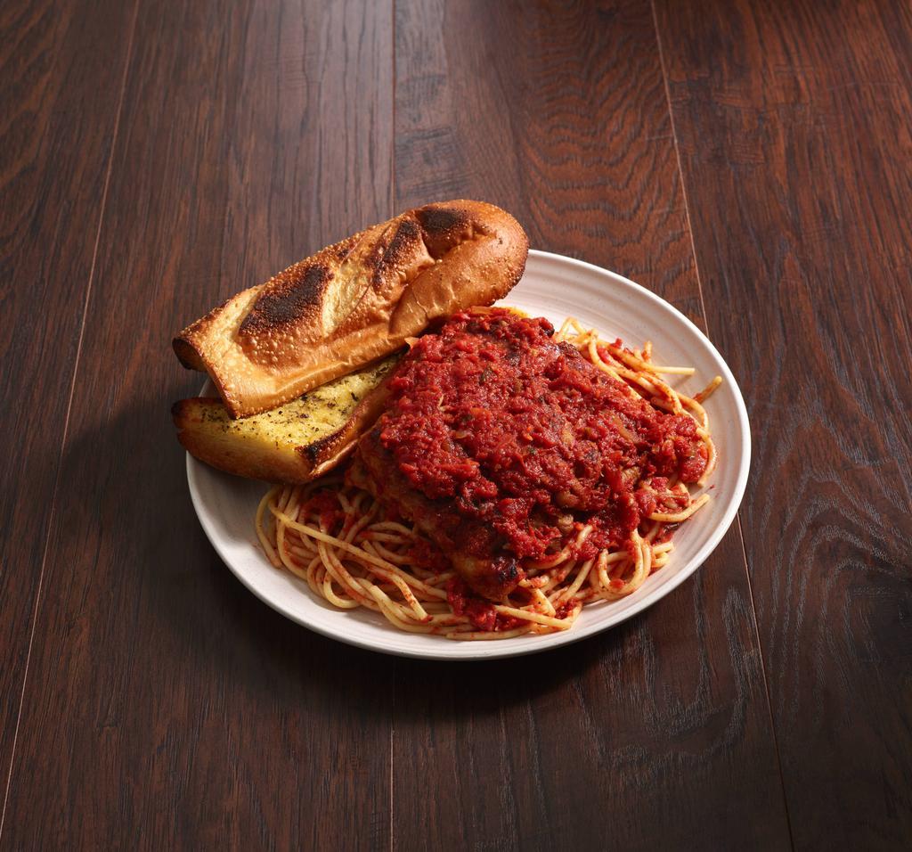 Eggplant Parmigiano · Layers of battered eggplant in a light marinara, topped with Parmigiano cheese baked and served with a side of spaghetti.