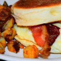 Bacon, Egg and Cheese Sandwich · On a grilled bolo served with homefries.