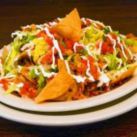 Mexican Nachos · Shredded chicken, refried beans, lettuce, topped with mozzarella cheese and pico de gallo.
