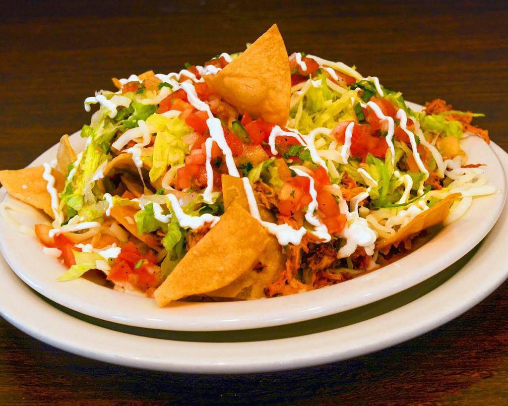 Mexican Nachos · Shredded chicken, refried beans, lettuce, topped with mozzarella cheese and pico de gallo.
