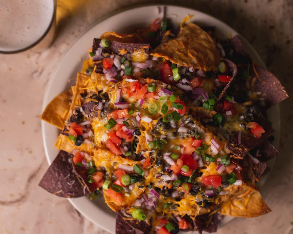 Nachos · tortilla chips, black beans, jack and cheddar cheeses, red onions, tomatoes and scallions served with roasted salsa and sour cream