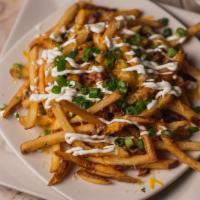 Loaded Fries · French fries tossed with cheddar and jack cheeses, bacon and scallions, then topped with sou...