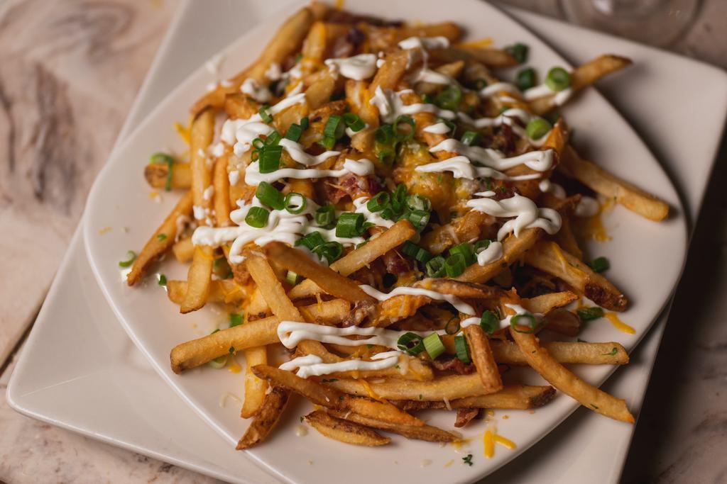 Loaded Fries · French fries tossed with cheddar and jack cheeses, bacon and scallions, then topped with sour cream