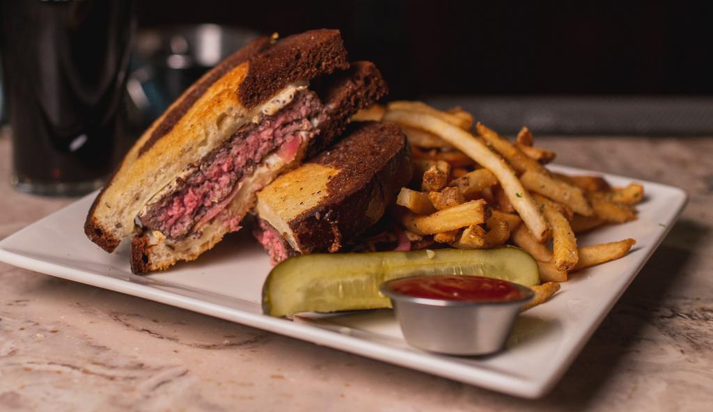 Paddy's Melt · Grilled marble rye, Cascade Natural beef patty, pickled red onions and Kilbeggan stone ground mustard sauce. Served with fries or malt vinegar potato chips.