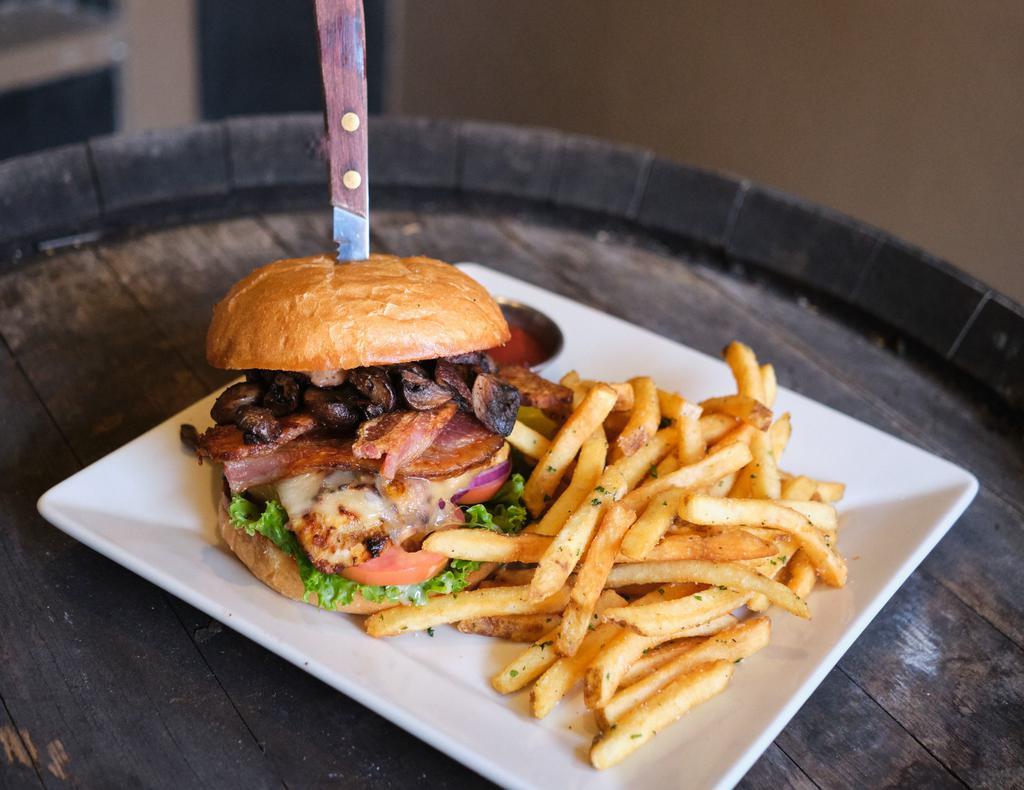 Bacon Mushroom Swiss Chicken Sandwich · Grilled marinated chicken breast topped with oven roasted crimini mushrooms, bacon and Swiss cheese on a pub roll with garlic aioli, lettuce, tomato and red onion. Served with Fries, sub a cup of lamb stew or side side salad for an additional charge.
