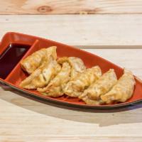 Fried Gyoza · Meat and vegetable dumpling with dumpling sauce. 7 pieces.