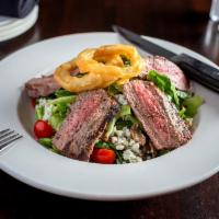 Steakhouse Salad · Rib eye steak strips, mixed greens, garlic roasted mushrooms, red onions, bleu cheese crumbl...