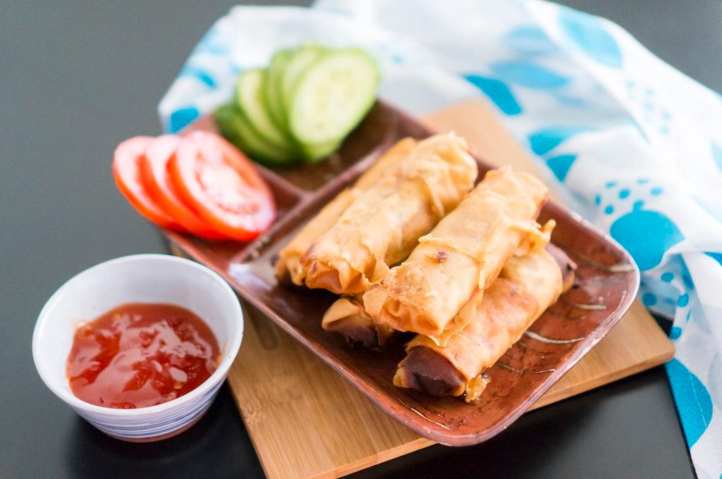   Egg Rolls with Cucumber Slices 素炸春卷伴青瓜 · Crispy dough filled with minced vegetables.