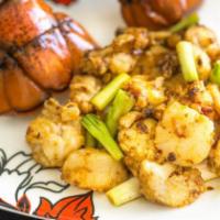 Stir Fried Lobster and Scallop 龍蝦帶子球 · Cooked and seasoned mollusk.