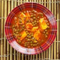 59. Mattar Paneer · Fresh garden peas with homemade cottage cheese cooked with spices in mild sauce.
