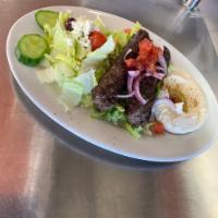 Kofta Kabob Plate · 2 skewers of marinated grilled ground beef served with couscous or rice, Greek salad or tabb...