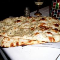 Mixed Naan · Traditional naan with garlic and onion mixed with basil and cilantro.