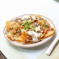 Nachos with Cheese and Meat · Comes with choice of protein.