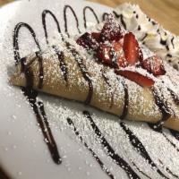 Strawberry and Nutella Crepe · Topped with powdered sugar, whipped cream and syrup.