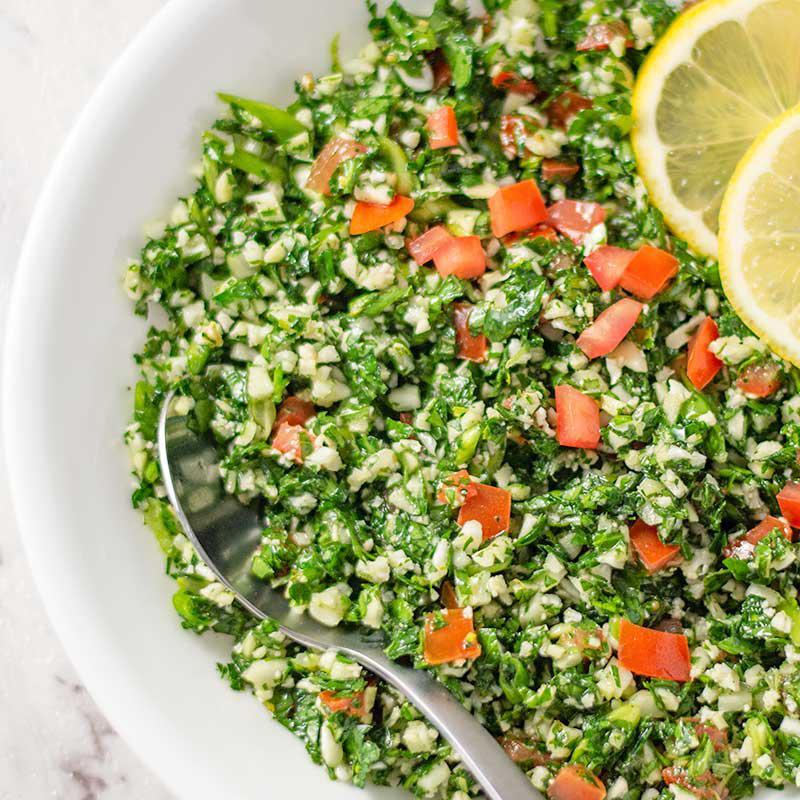Tabbouleh Salad · Fresh chopped parsley pre mixed with tomatoes, onions, and bulgur wheat, all toasted with lime juice and olive oil.
