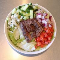 Steakhouse Salad · Iceberg with grilled steak, red onions, bleu cheese crumbles, cucumber and tomatoes. Recomme...
