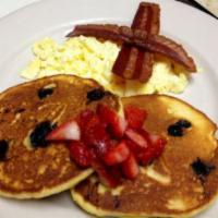 American Egg Combo · Fresh scrambled eggs served with two of our made from scratch blueberry corn cake topped wit...