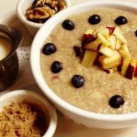 Classic Apple Raisin Oatmeal · Whole rolled oats, raisins, blueberries and apple slices served with a side of walnuts, brow...