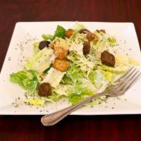 Caesar Salad · Romaine lettuce tossed on homemade Caesar dressing, Parmesan cheese and croutons.