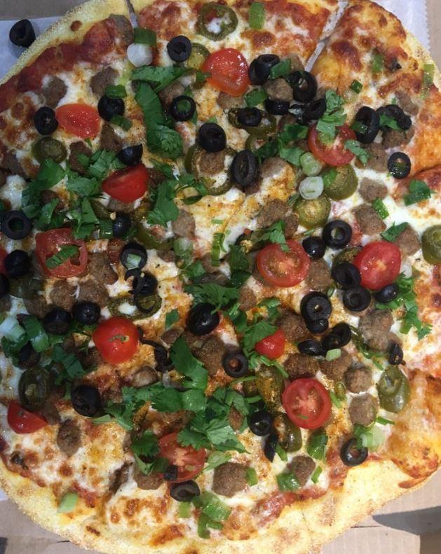 Amigos Latino Lovers Pizza · Mozzarella, refried bean sauce, ground beef, jalapenos. After cooking: green onion, black olives, cherry tomato and cilantro.