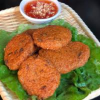 A7. Tod Mun · Fish cake. Crispy fish cake served with sweet and chili sauce topped with crushed peanut.