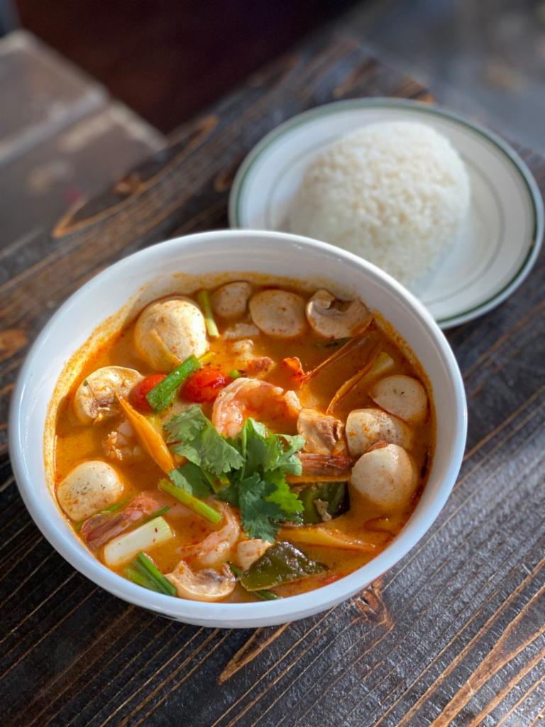 Tom Yum Narm Khon Tha Lay (Large Seafood Tom Yum) · Thai hot and sour soup with shrimp chili paste, fishball, Shrimp and Calamari mixed with lemongrass, lime leaves, lime juice, fish sauce, mushroom and milk topped with cilantro. Served with Jasmine white rice.