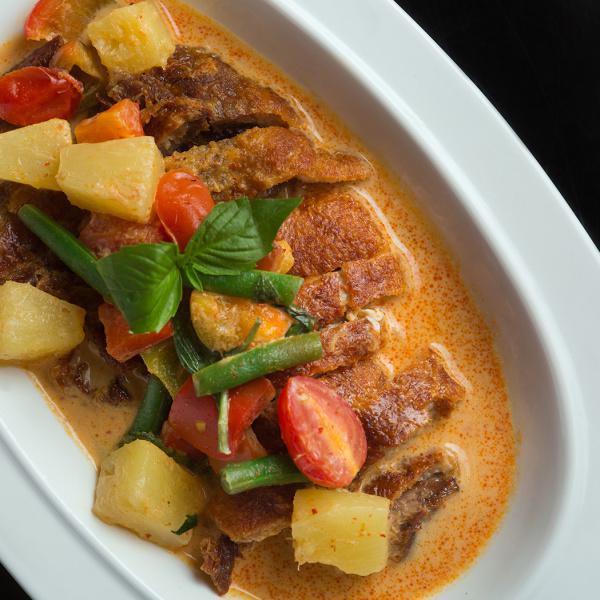 F1. Noodies Duck Curry · Crispy duck breast, coconut milk, panang curry paste, cherry tomatoes, pineapple, green bean, bell peppers, fresh basil leaves, kaffir lime leaves served with jasmine white rice. Gluten-free.