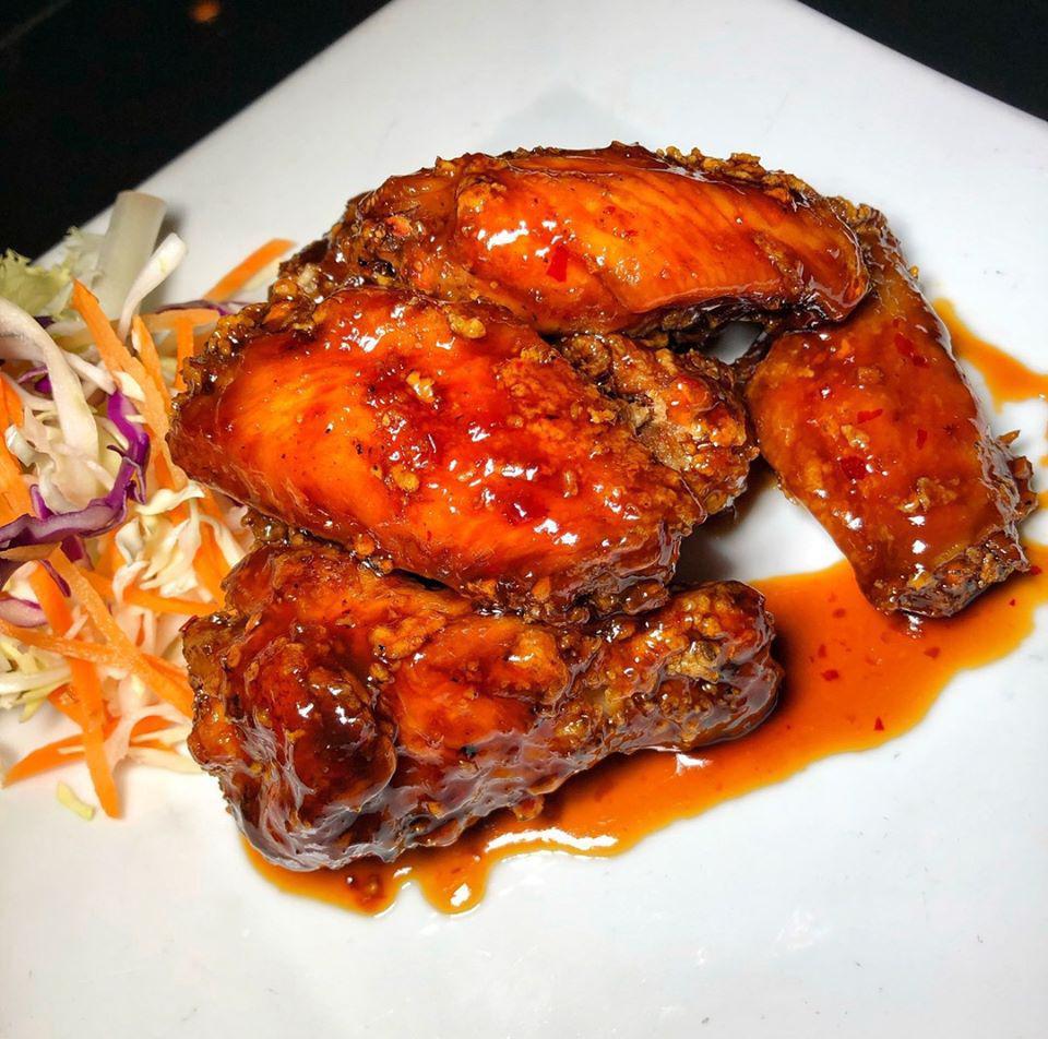 Asian Chicken Wings · Plump chicken wings deep fried and tossed in a spicy teriyaki glaze.