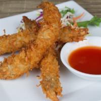 Coconut Shrimp · Jumbo white shrimp battered with shaved coconut and served with sweet chili sauce.