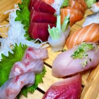 Sushi Deluxe Platter · Tuna roll with 10 pieces of sushi shrimp, yellowtail, salmon, tuna, striped bass, Spanish ma...