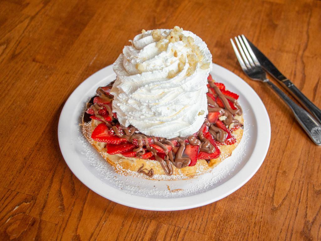 Fresh Strawberry Whipped Cream Waffle · Our Belgium waffle topped with fruit and powered sugar, topped with whip cream and macadamia nuts.