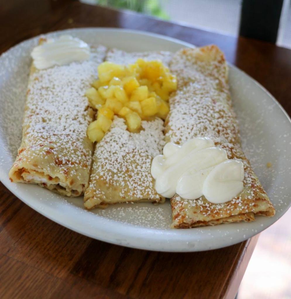 Sour Cream and Fresh Pineapple Crepes · Delicate & thin homemade crepes filled with sour cream filling and lightly sprinkled with powdered sugar.