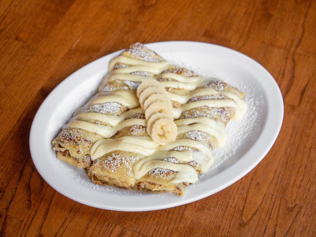 Sour Cream and Fresh Banana Crepes · Delicate & thin homemade crepes filled with sour cream filling and lightly sprinkled with powdered sugar.