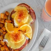 Traditional Eggs Benedict · Canadian bacon on top of our homemade English muffin covered with hollandaise sauce and come...