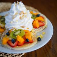 Fresh Fruit Rainbow Pancakes · Three macadamia nut pancakes topped with fresh  banana, papaya, strawberries, kiwi, pineappl...