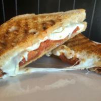 Proscuitto Panini · Served with mozzarella and roasted tomato.