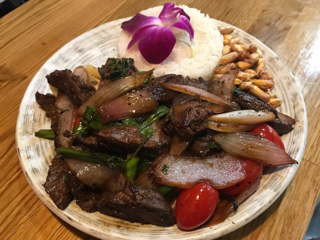 Lomo saltado · Sautéed beef with red onions and tomatoes served with white rice and French fries.