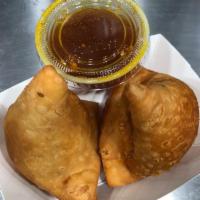 Vegetable Samosa  · 2 pieces. Wheat flour shell stuffed with spiced potatoes, onions green peas, and spices.