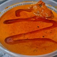 Butter Chicken  · Boneless chicken cooked in butter with spices, cream and almonds.