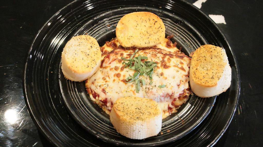 Lasagna Foraggio · Ricotta, mozzarella, and parmesan cheese layered with pasta, beef, our delicious pizza sauce, then seasoned with Italian herbs and baked in our brick oven. Served with garlic toast points.