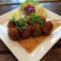 Luuk Shin Ping · Homemade pork balls grilled to perfection served with sweet and tangy chili sauce. 