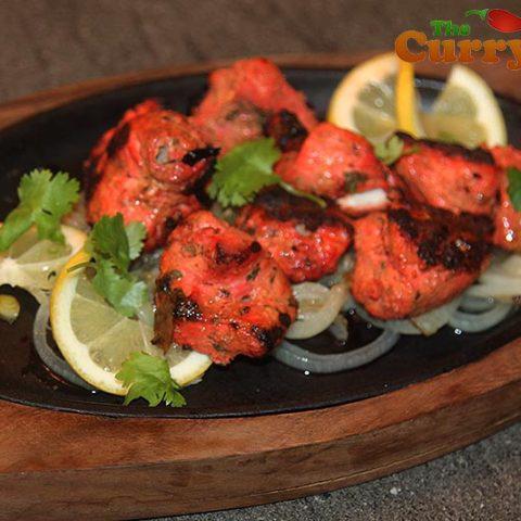 Chicken Tikka Tandoor · Chicken breast marinated in yogurt, ginger garlic, and mild spices. Baked in a special clay oven and served on a sizzler