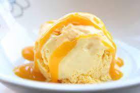 Vanilla Ice-cream topped with Mango Dressing · 