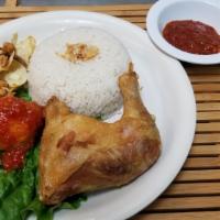 Nasi Uduk Komplit · Indonesian coconut rice plate consisting of fried chicken, hard boiled egg topped with spicy...