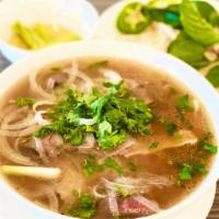 P1. Pho Dac Biet Queenz · Special combination noodle, sliced of eye-round, flank, brisket, shredded tripe, tendon and ...